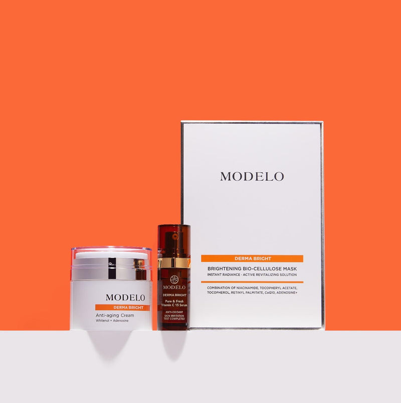 Gama MODELO Derma Bright — cremă, ser cu vitamina C și mască — pe fundal portocaliu