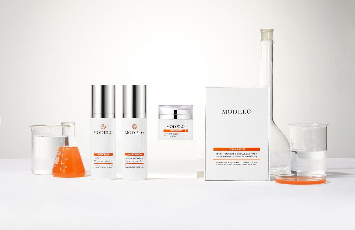 The MODELO Derma Bright range beside laboratory beakers and a flask